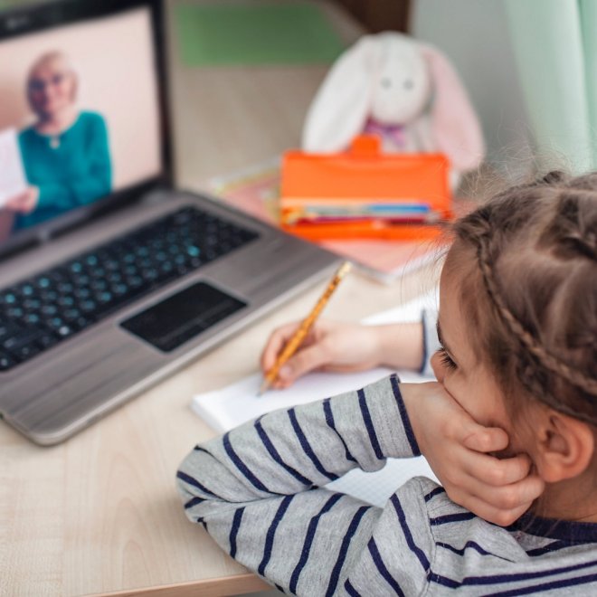 Pretty stylish schoolgirl studying homework math during her online lesson at home, social distance during quarantine, self-isolation, online education concept, home schooler